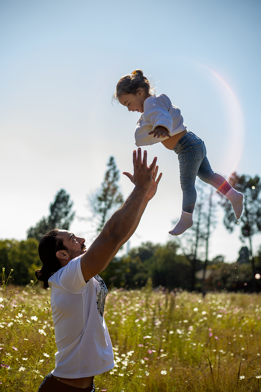 dad throwing daughter into air